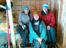 family standing next to home in alaska